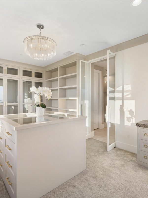 Luxurious Walk-In Closet with Modern White Cabinetry Luxurious Walk-In Closet with Modern White Cabinetry