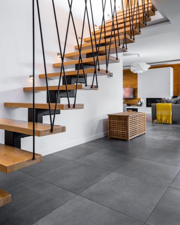 Contemporary Floating Staircase Design – San Jose Home Renovation Modern floating wood staircase with black steel railings and gray tile floors perfect for a home addition